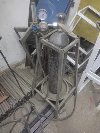 Баллон со сжатым газом на сварочной стойке с редуктором и